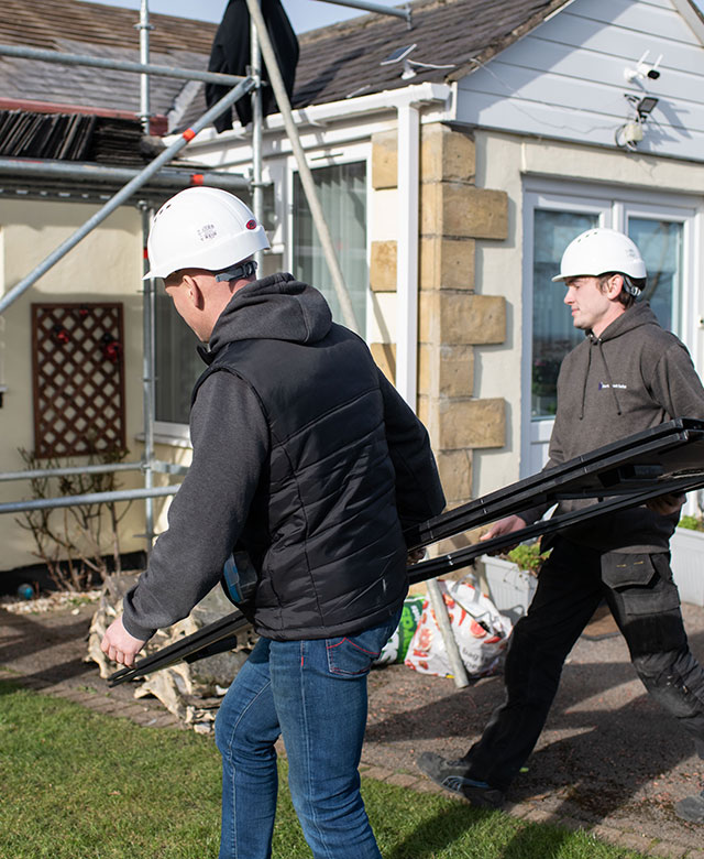 north east solar employees putting solar panels on a domestic house