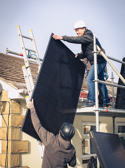 north east solar employees putting solar panels on a domestic house