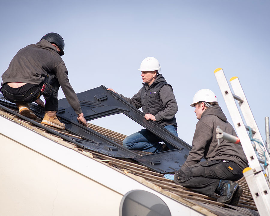 north east solar employees putting solar panels on a domestic house
