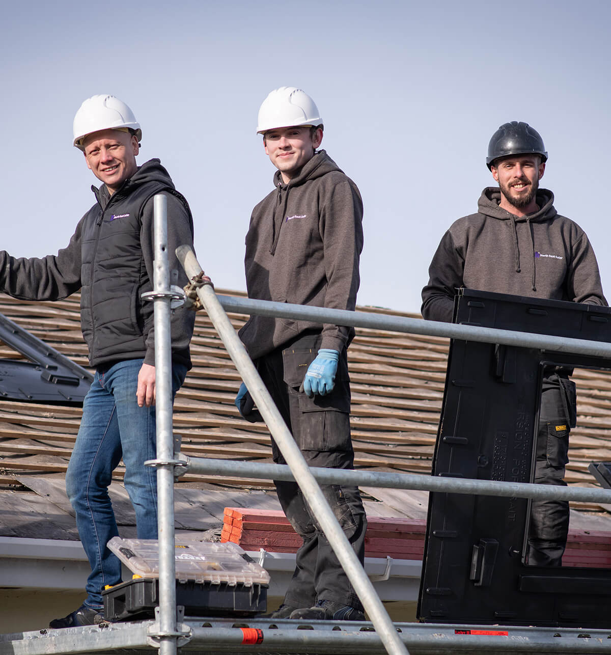 north east solar employees putting solar panels on a domestic house